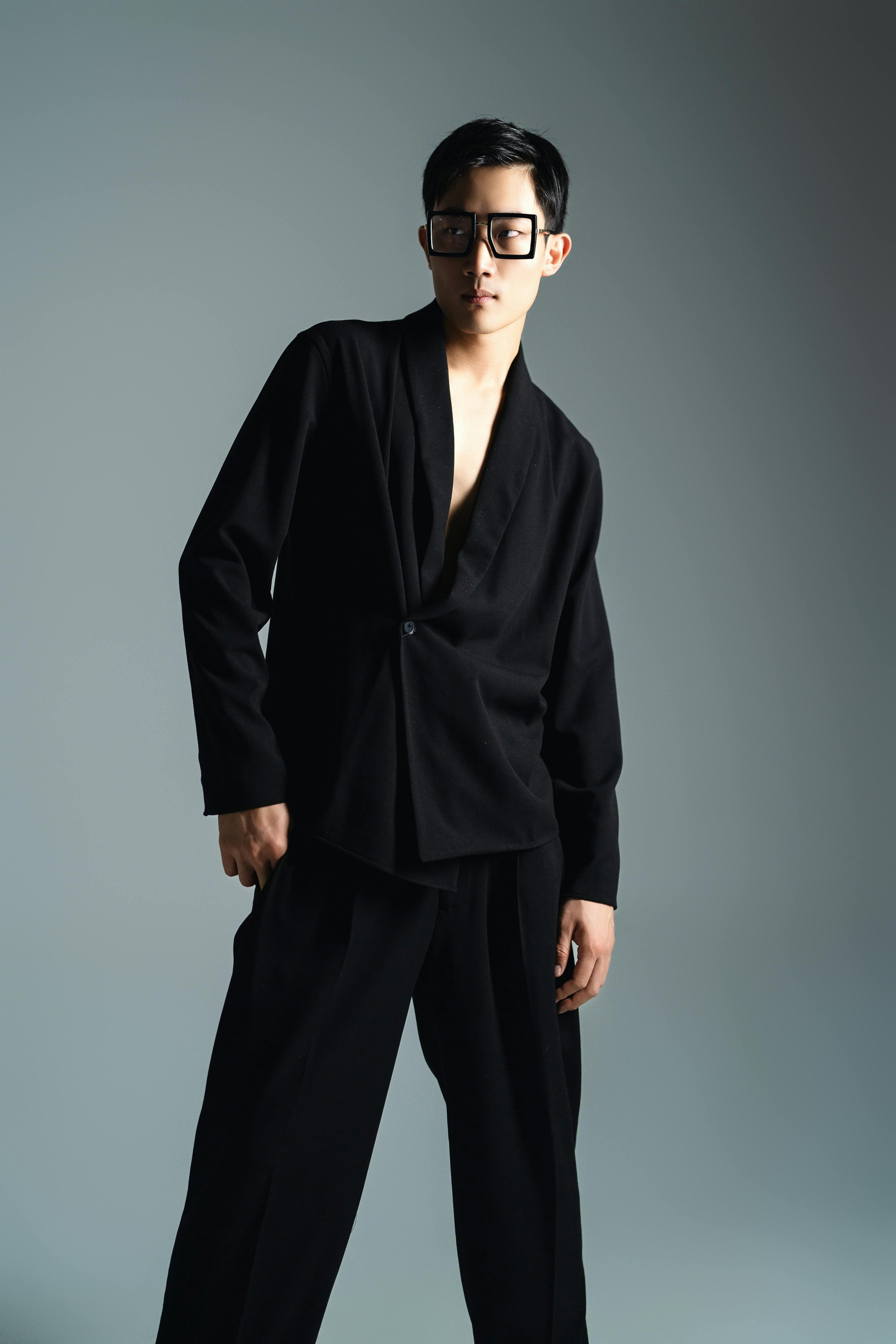 Elegant studio photoshoot of a male model in modern fashion attire, showcasing contemporary style in London.