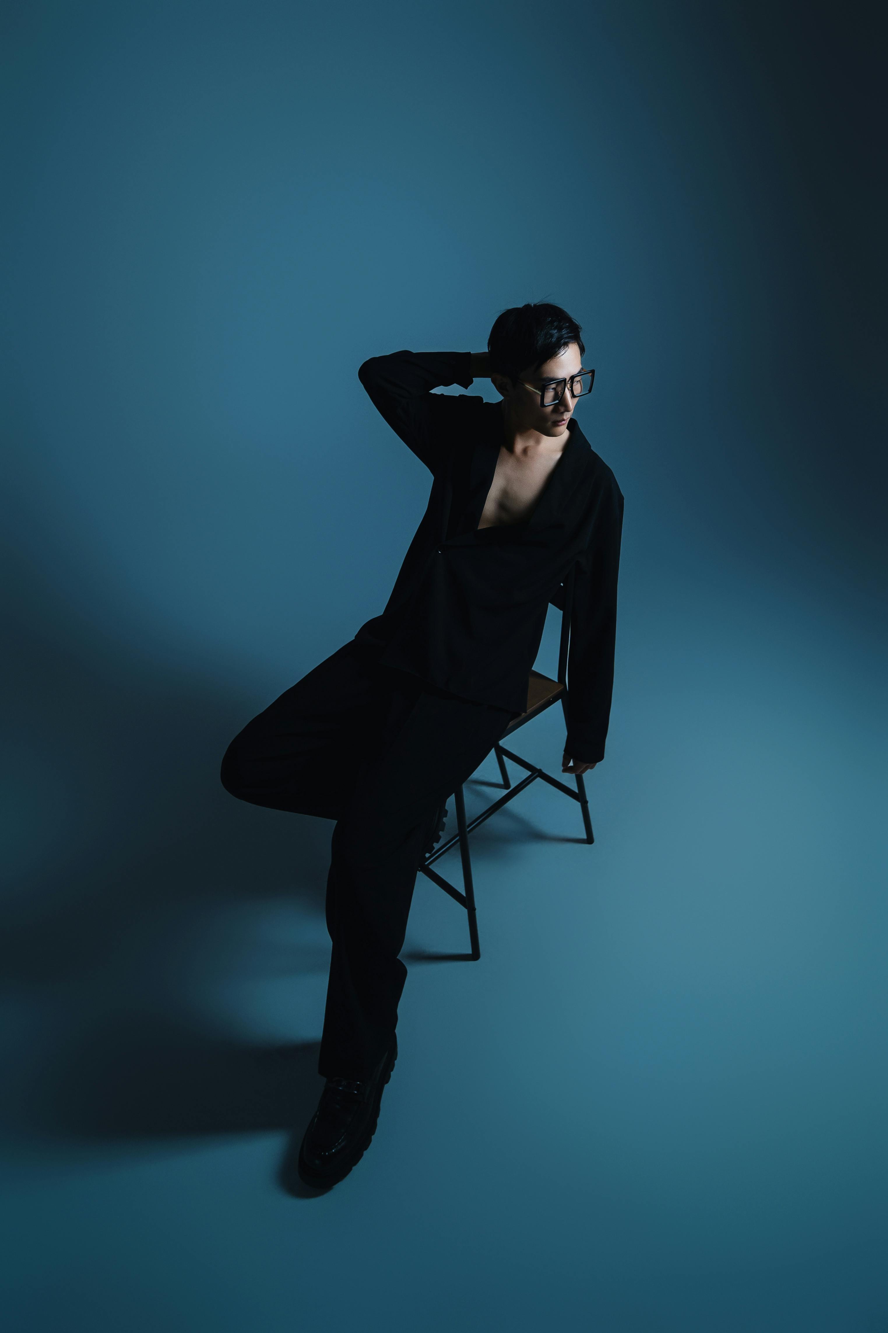 Artistic portrait with sophisticated attire and creative lighting.