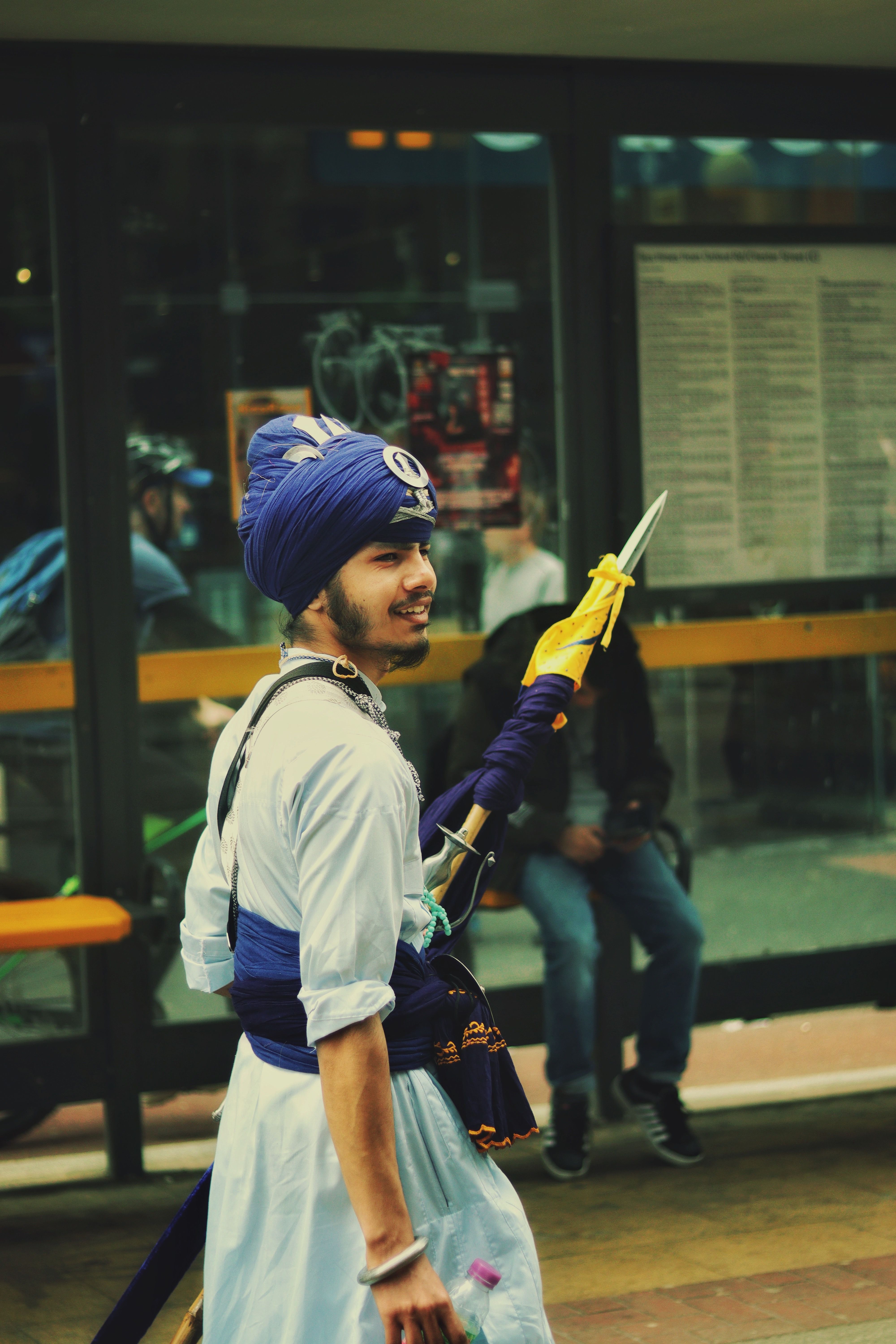 Sikh Nihang warrior in traditional attire participating in a street parade in Manchester, UK.