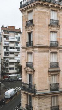 Charming Parisian building with classic architecture and balconies on a street corner.
