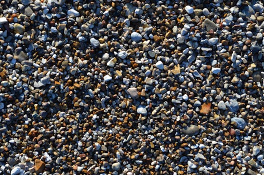 Vibrant multicolored pebbles on a beach captured in a close-up view.