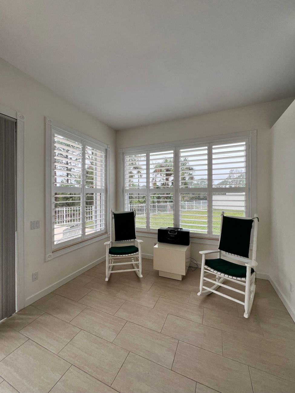 Sunroom with made-to-measure shutters controlling the afternoon light