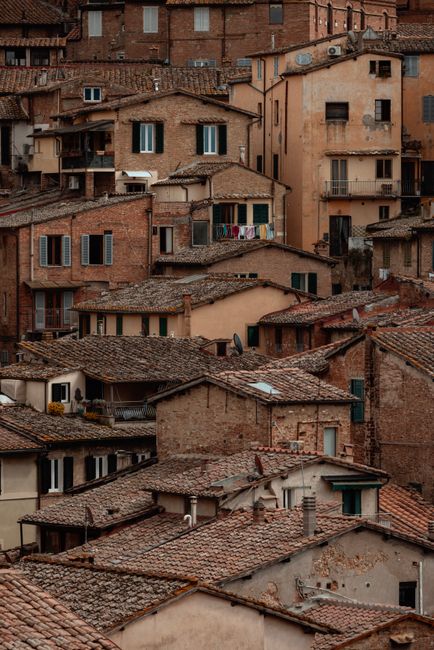 Charming view of traditional Tuscany architecture with iconic terra cotta rooftops.