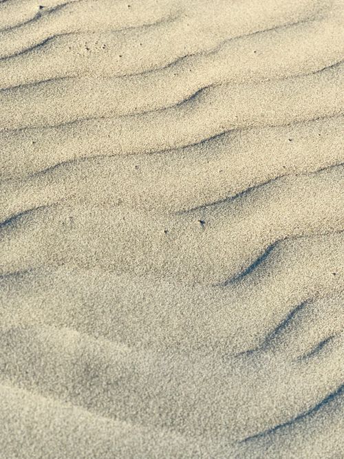 Free Close-up view of sand ripples on Cox's Bazar beach, capturing the natural texture and patterns. Stock Photo