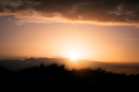 A stunning sunrise over a tranquil landscape with vibrant sky colors enhancing the natural beauty.