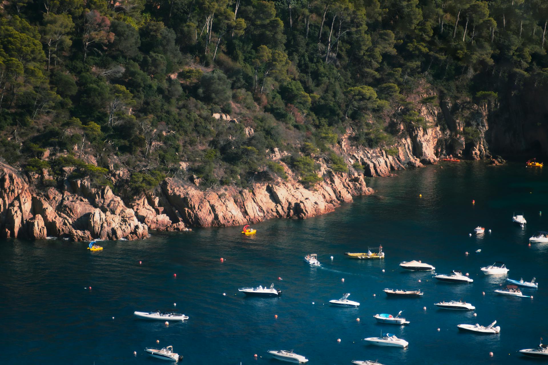 Boats in a Mediterranean bay in Spain with a classic town