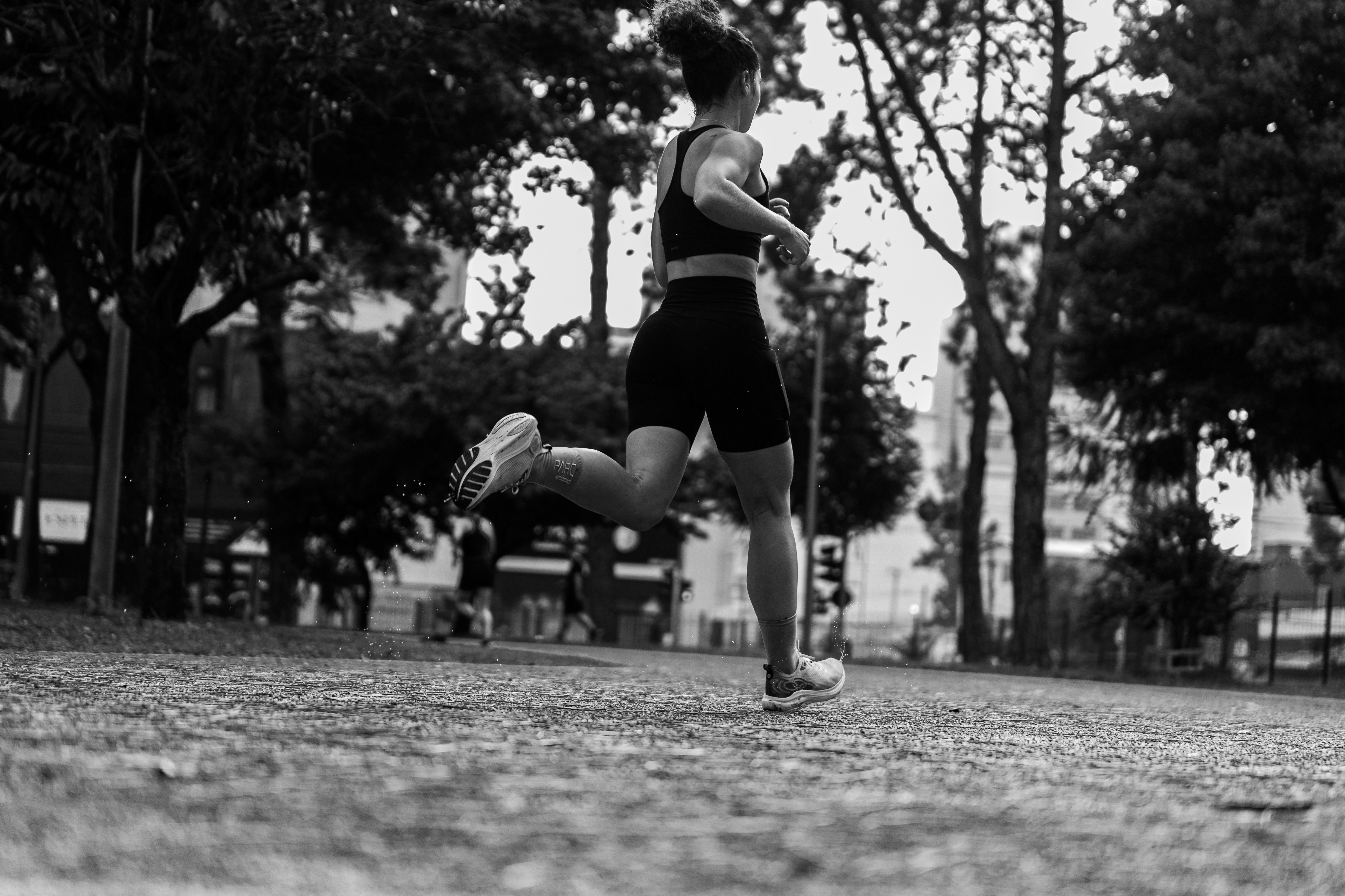 Woman Running in City Park: Black and White Shot · Free Stock Photo