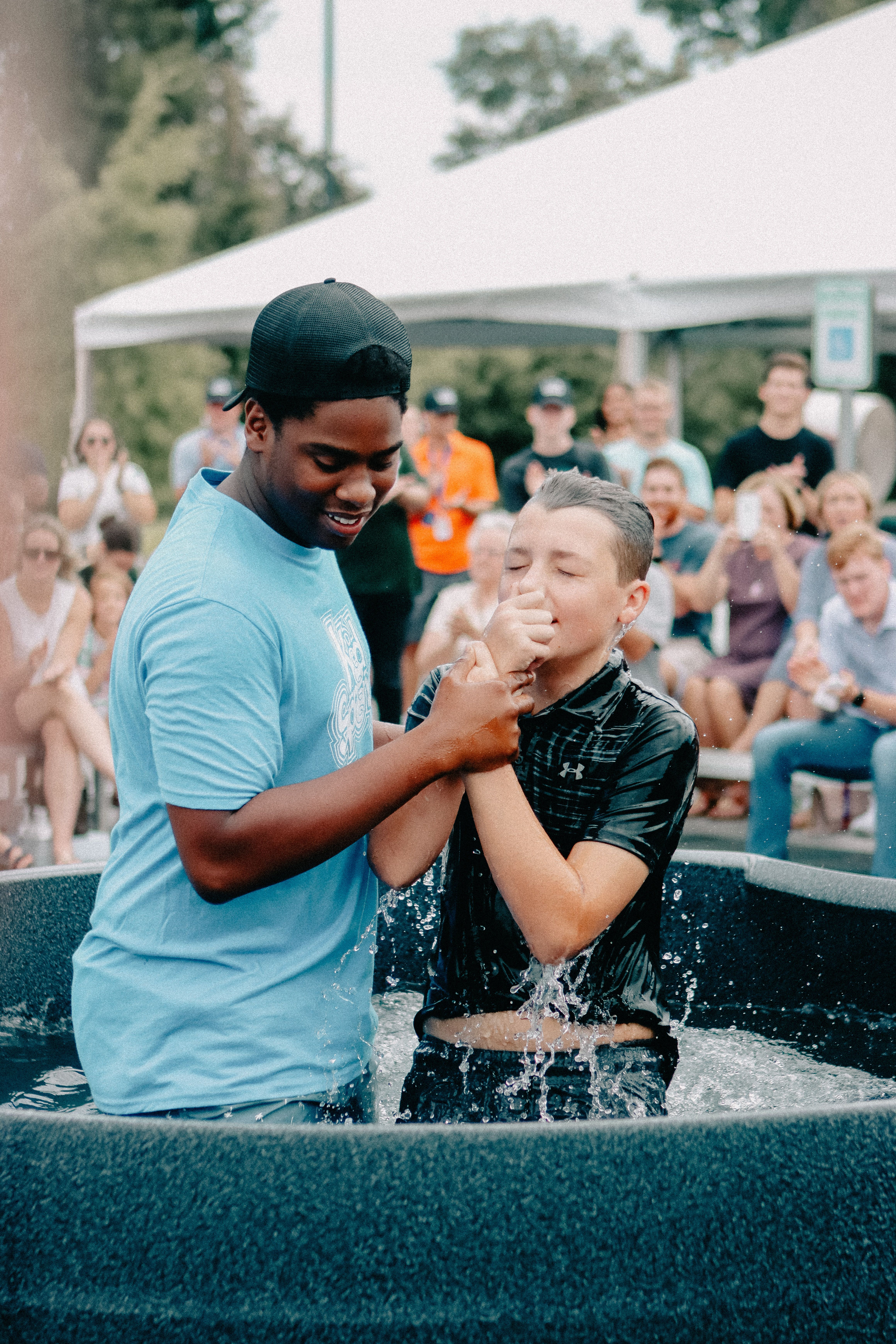 A vibrant outdoor baptism scene capturing a joyous celebration in Clemson.