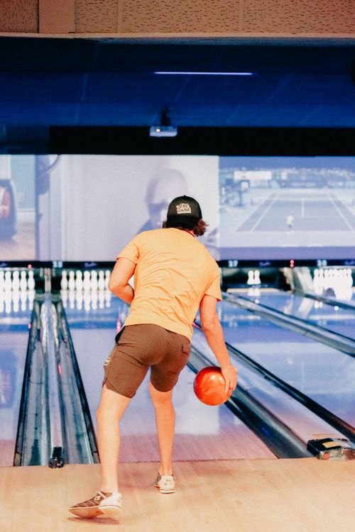 Free A teenager enjoys a bowling game during a fun youth event. Stock Photo