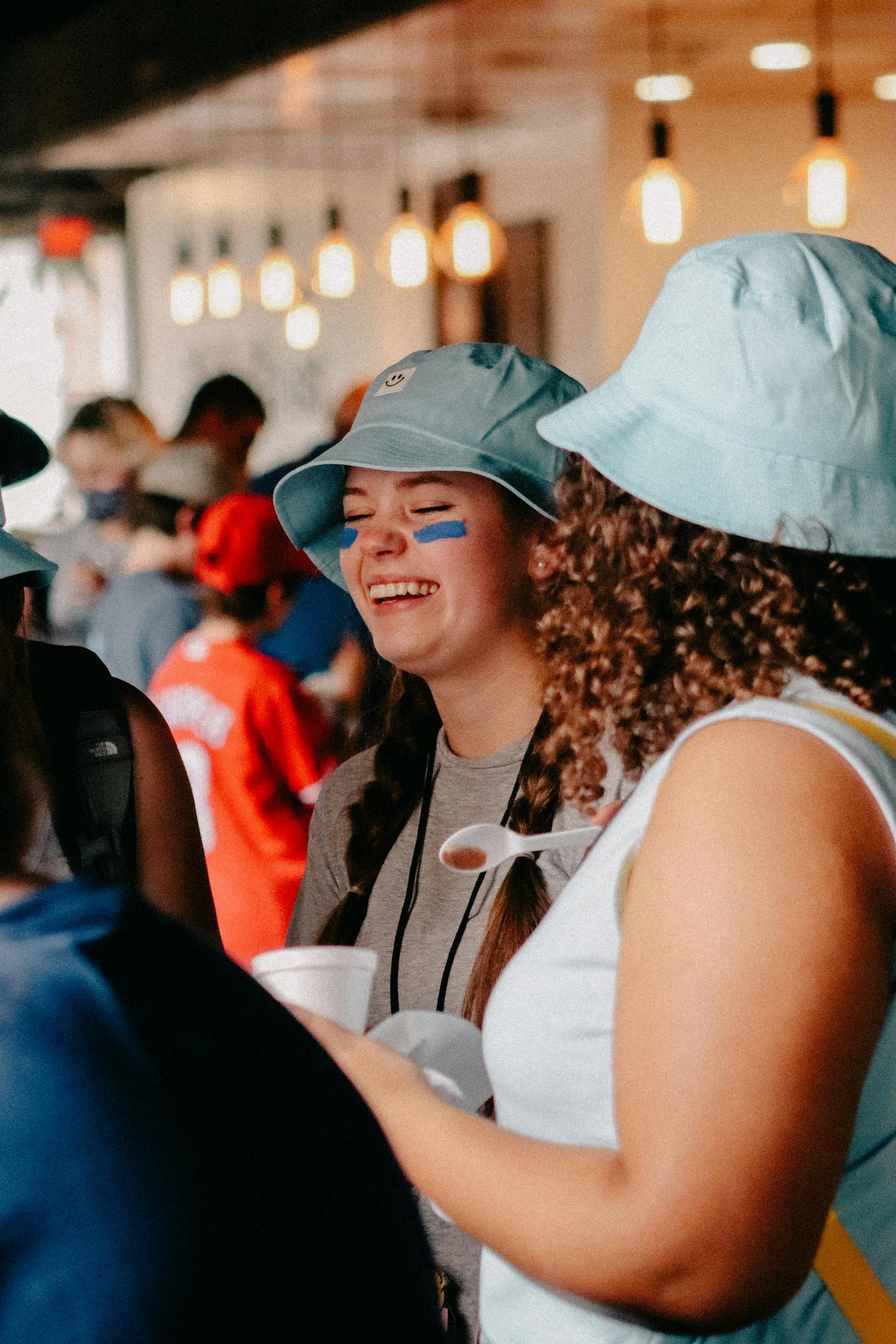 Teens laughing together at an indoor youth gathering