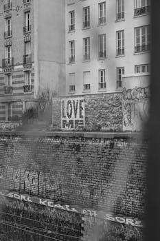 Monochrome cityscape with prominent graffiti and urban architecture.