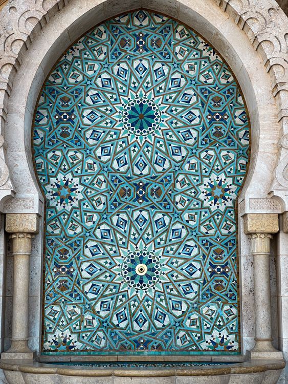 A stunning Moroccan tile mosaic design in an archway with intricate patterns and colors