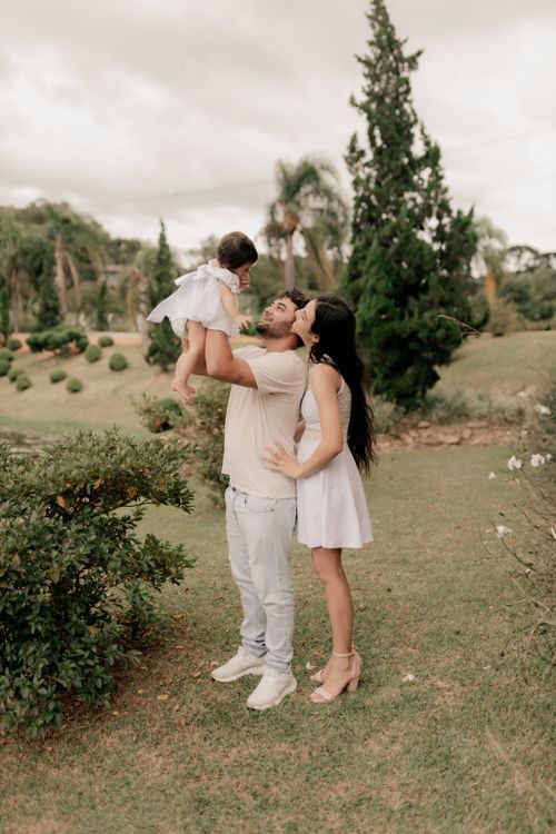 Free Family of three enjoying a sunny day in the park, embracing nature. Stock Photo