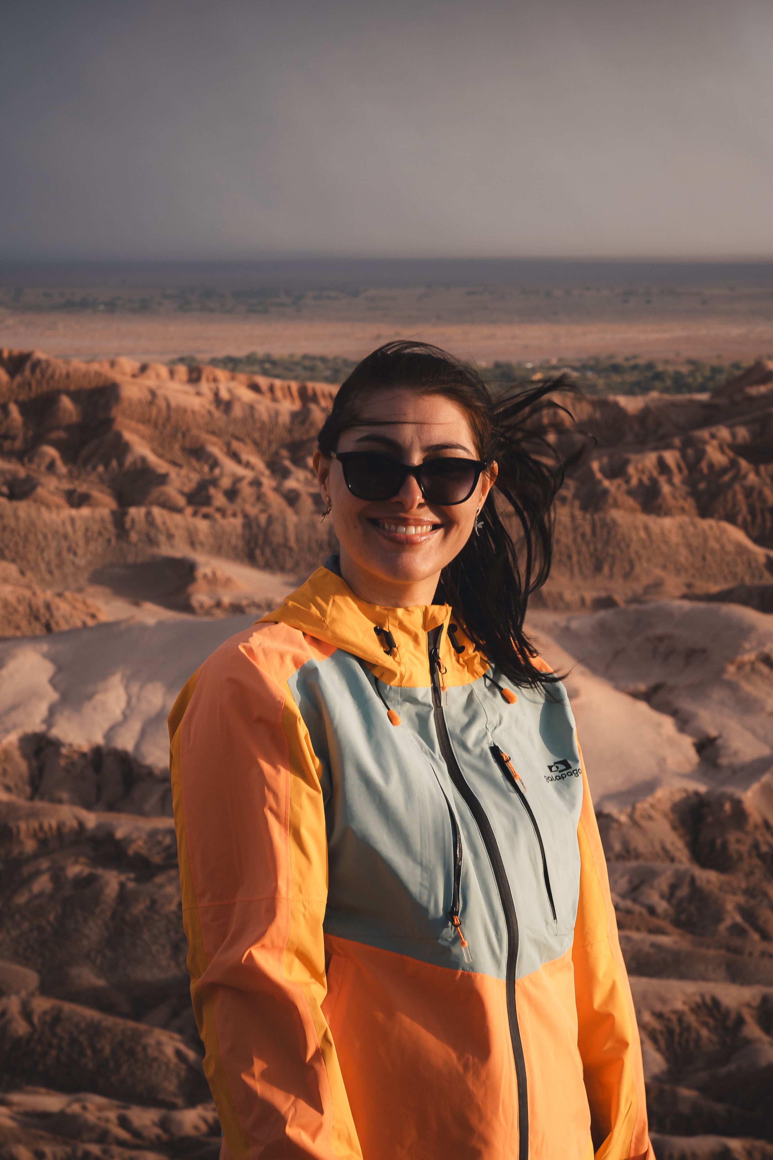 Woman enjoying a sunny day in a striking desert landscape.