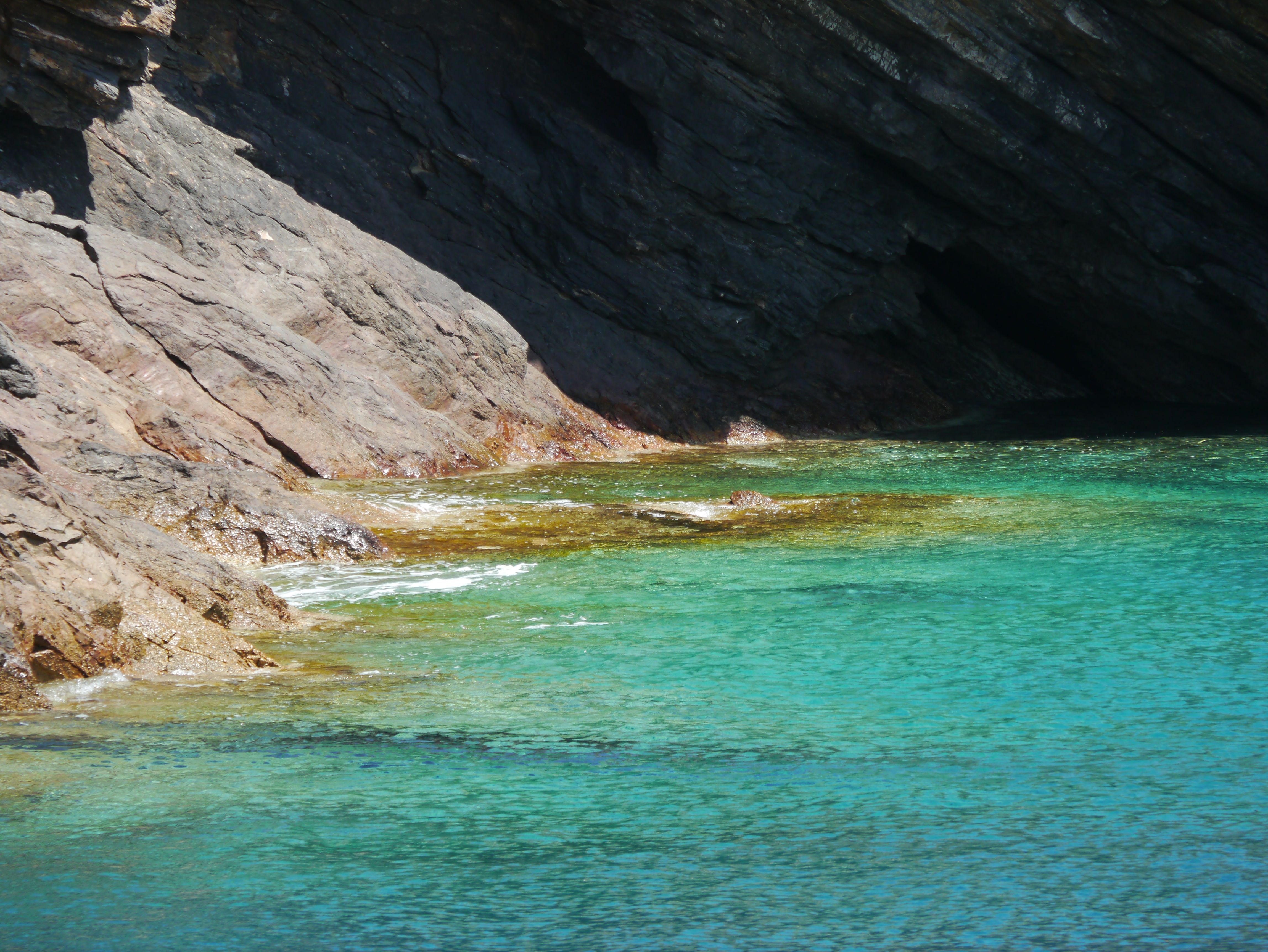 Serene Rocky Coastline with Clear Blue Water · Free Stock Photo