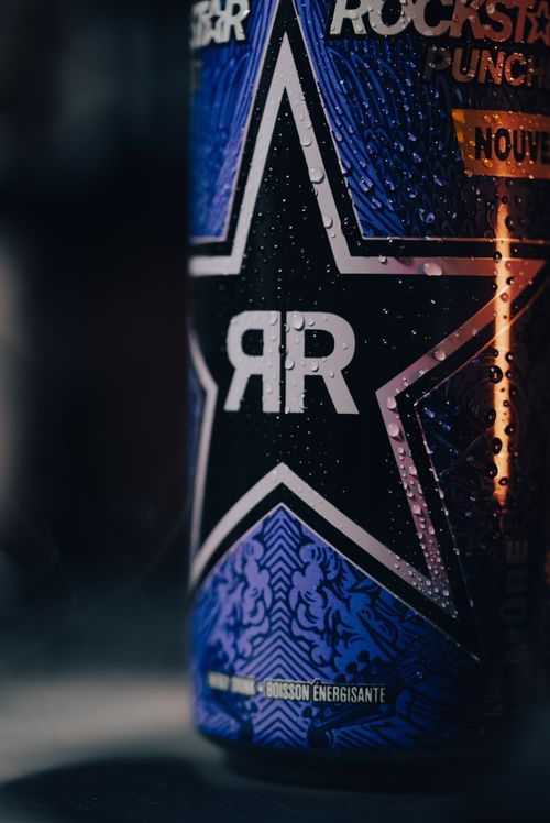 Free Detailed shot of a Rockstar energy drink can with water droplets and vibrant branding. Stock Photo