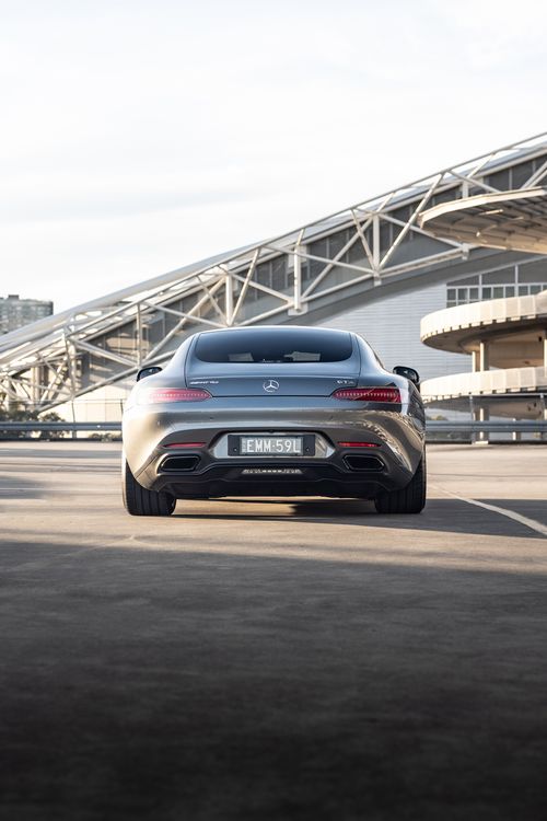 Free Rear view of a sleek Mercedes-AMG GT parked in Sydney, showcasing modern architecture. Stock Photo