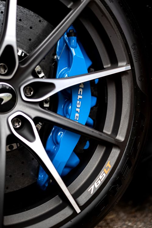 Free Detailed shot of McLaren 765LT wheel showing blue brake caliper and sleek design in Sydney. Stock Photo