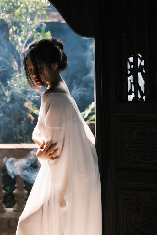 Women Flowing Robe Elegant Woman in Flowing Robe with Indoor Light · Free Stock Photo