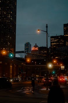 Night scene of a city street with the illuminated Royal York Hotel sign.