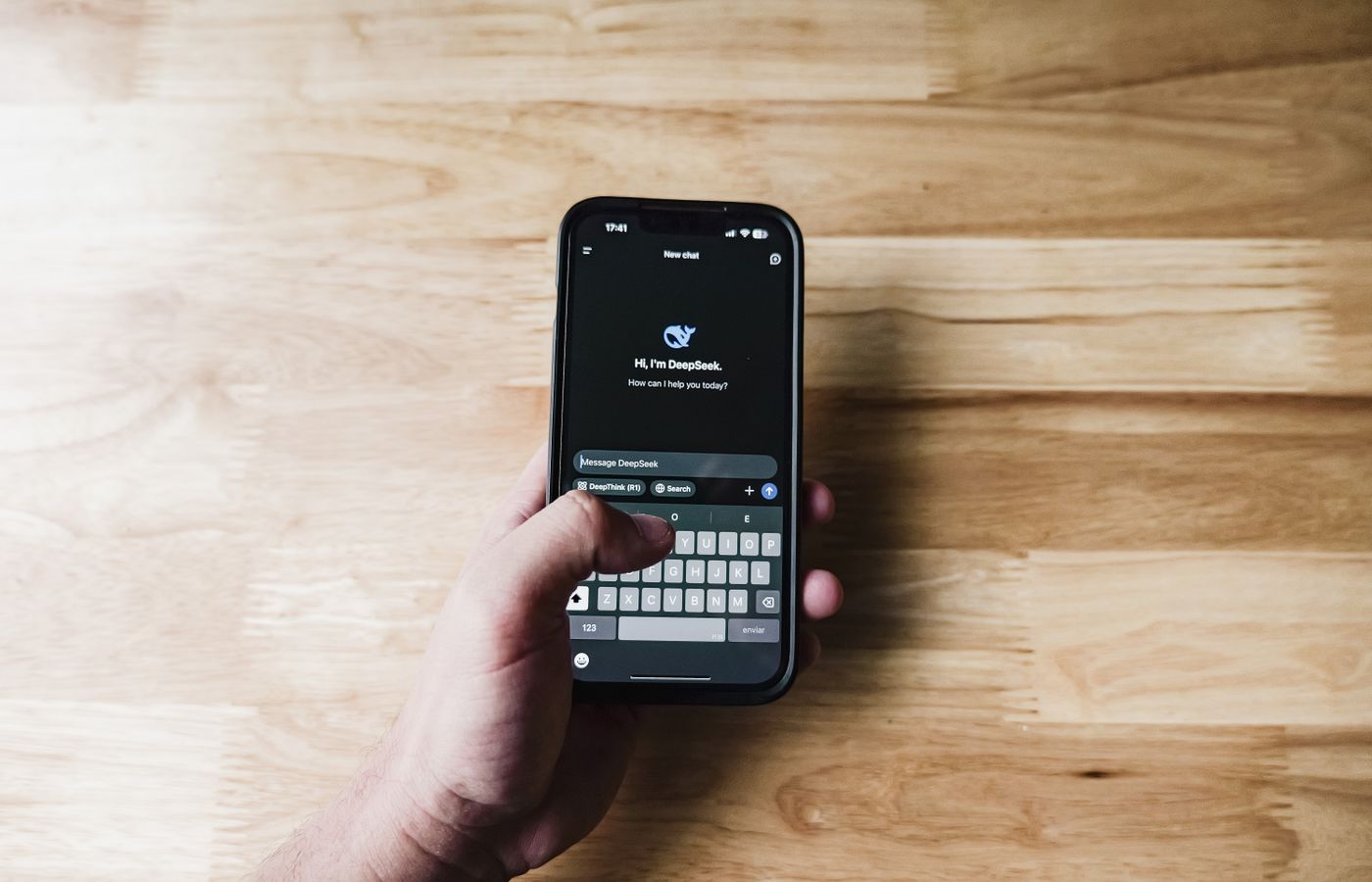 A person interacting with an AI assistant on a smartphone indoors.
