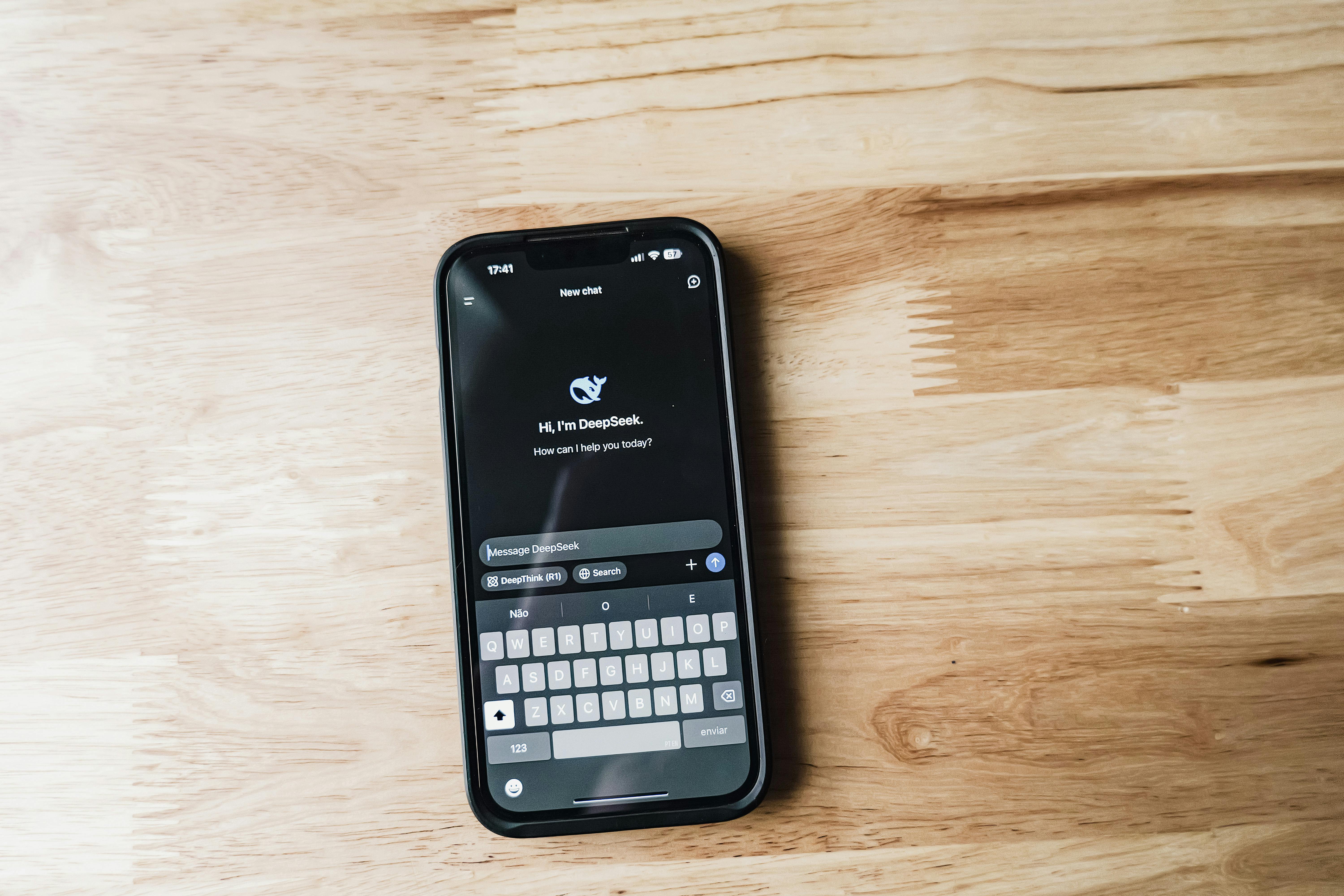 smartphone with ai chat interface on wooden surface