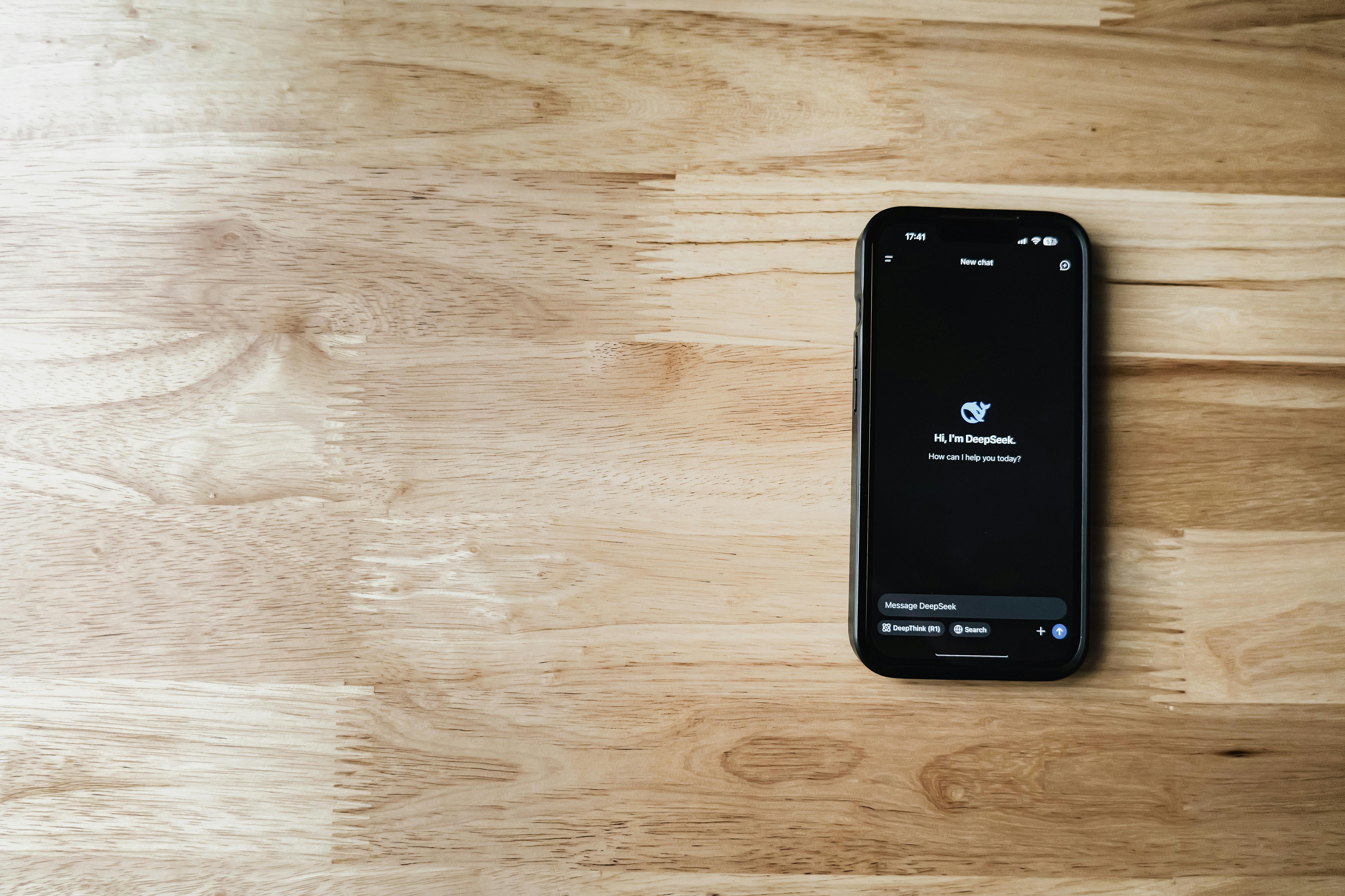 smartphone with ai chatbot on wooden surface