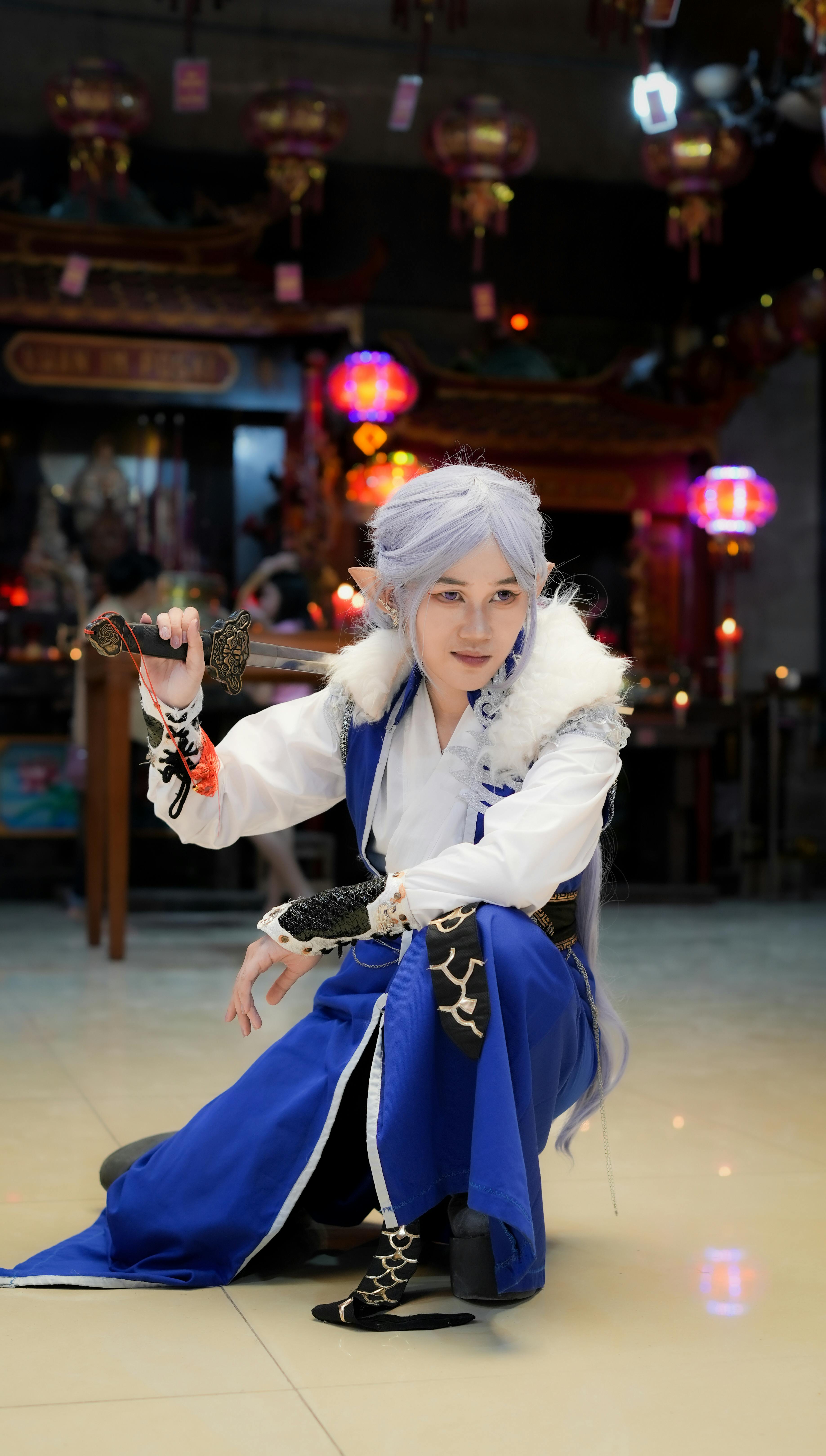 Dynamic anime cosplay portrait in an Indonesian temple with colorful lights.