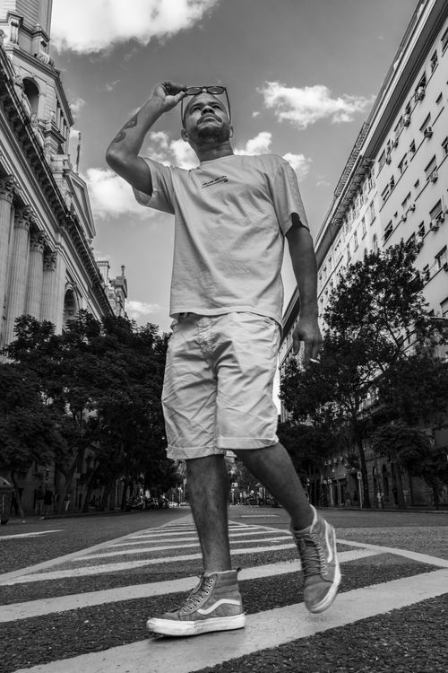 Free Black and white photo of a man walking in a Buenos Aires street, showcasing urban life. Stock Photo