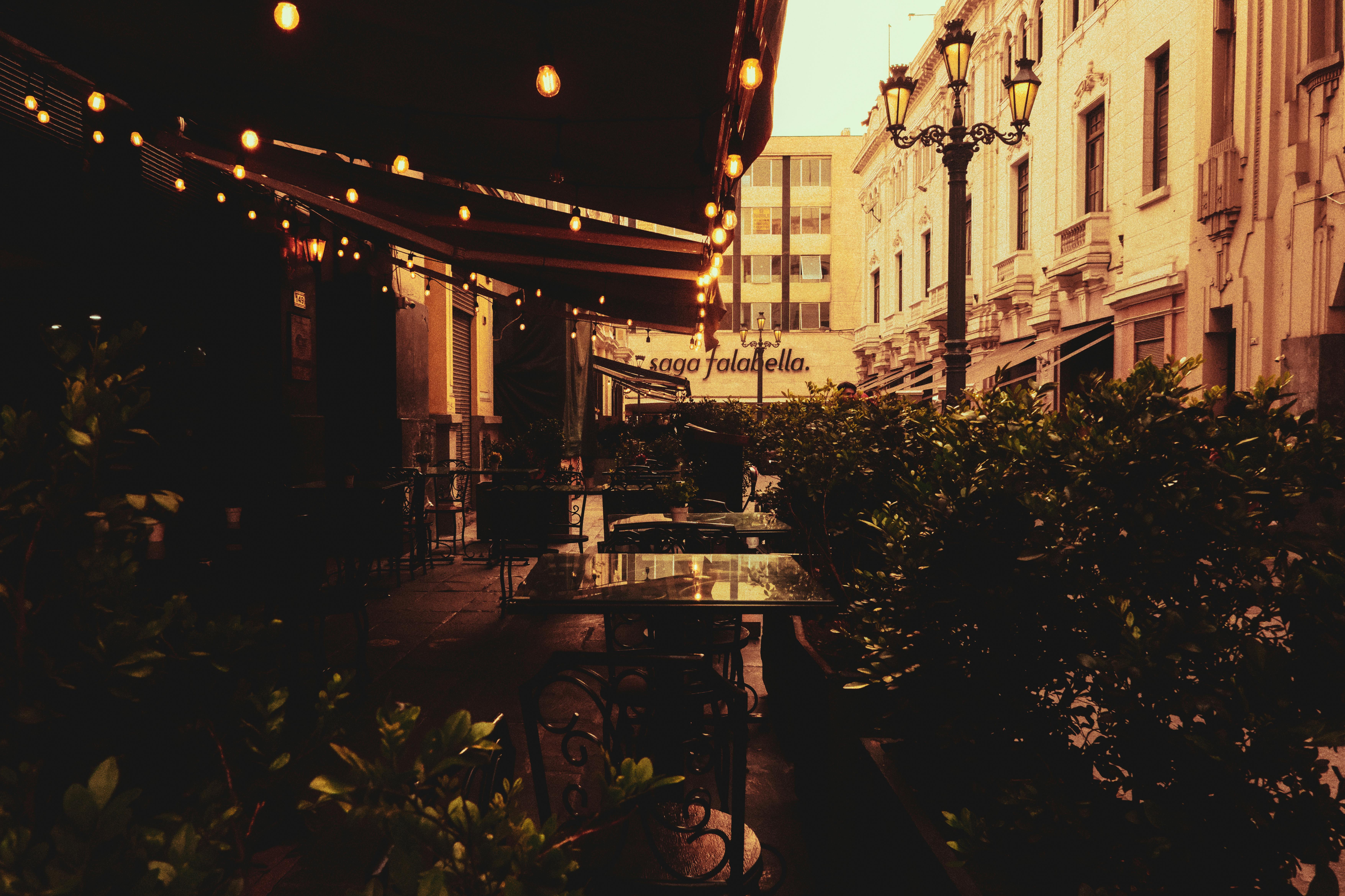 Warm evening ambiance at an outdoor café in a vintage city street.