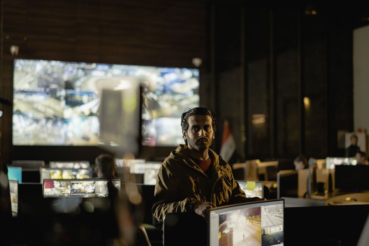 Modern security control room with a diverse team monitoring live surveillance feeds