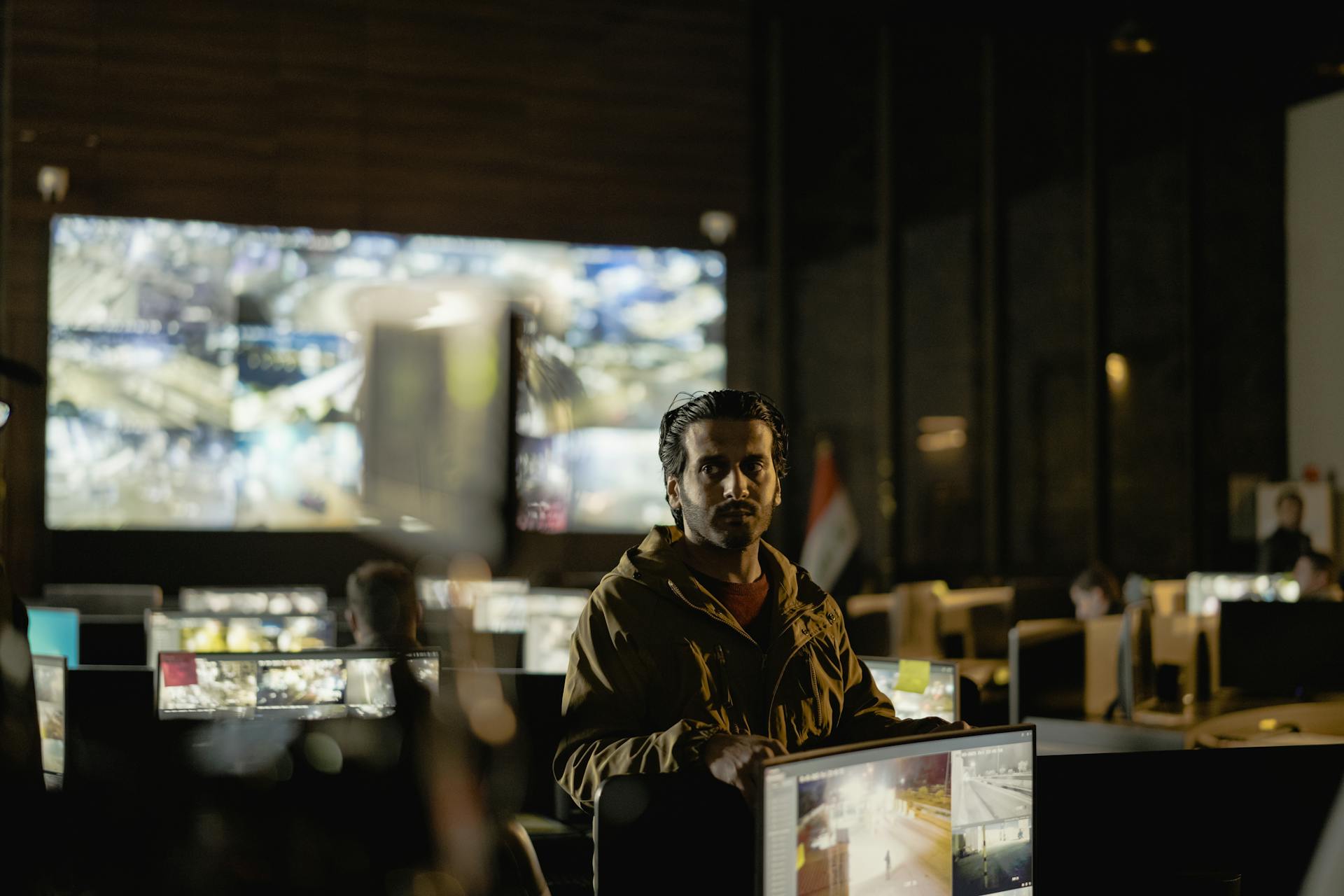 Modern security control room with a diverse team monitoring live surveillance feeds.