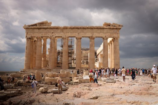 Spectacular view of the Parthenon in Athens, showcasing ancient Greek architecture amidst a bustling crowd.