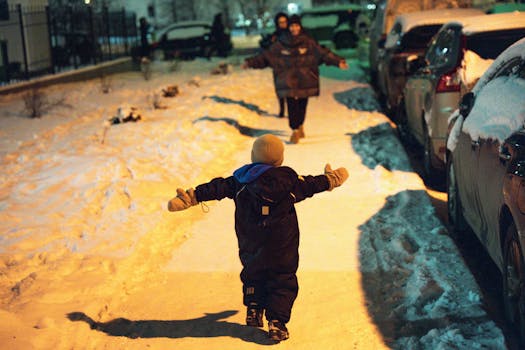 A joyful child running on a snow-covered street towards an adult in winter clothing.