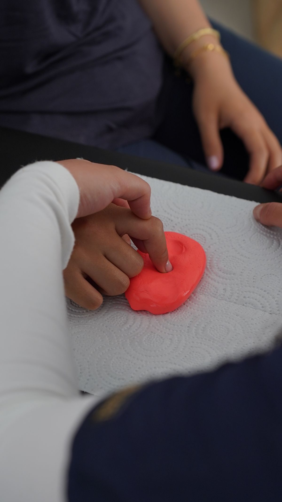 Hands working therapy putty during a sensory session