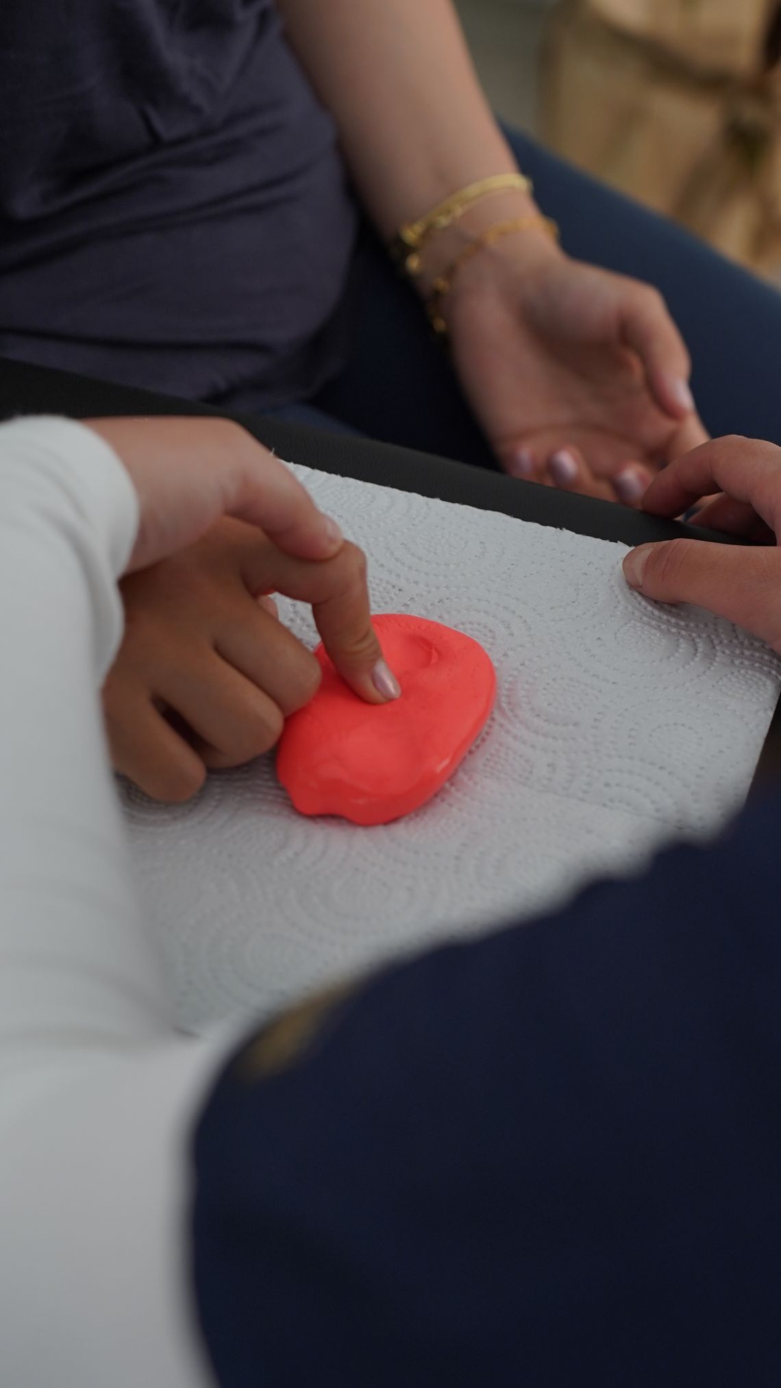 Children using their hands to explore soft clay during a sensory play activity