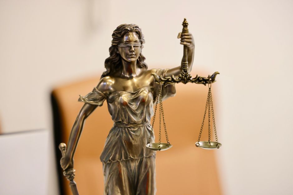 Close-up of Lady Justice statue holding scales — ExploreBwiti in Vancouver operates with non-negotiable safety standards: on-site medical professional, cardiac screening, and thorough intake