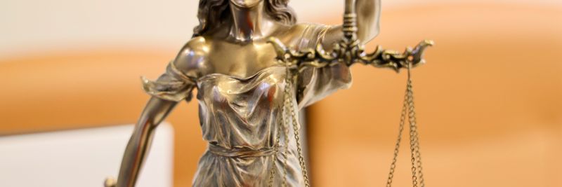 Detailed image of Lady Justice statue, symbolizing fairness and impartiality.