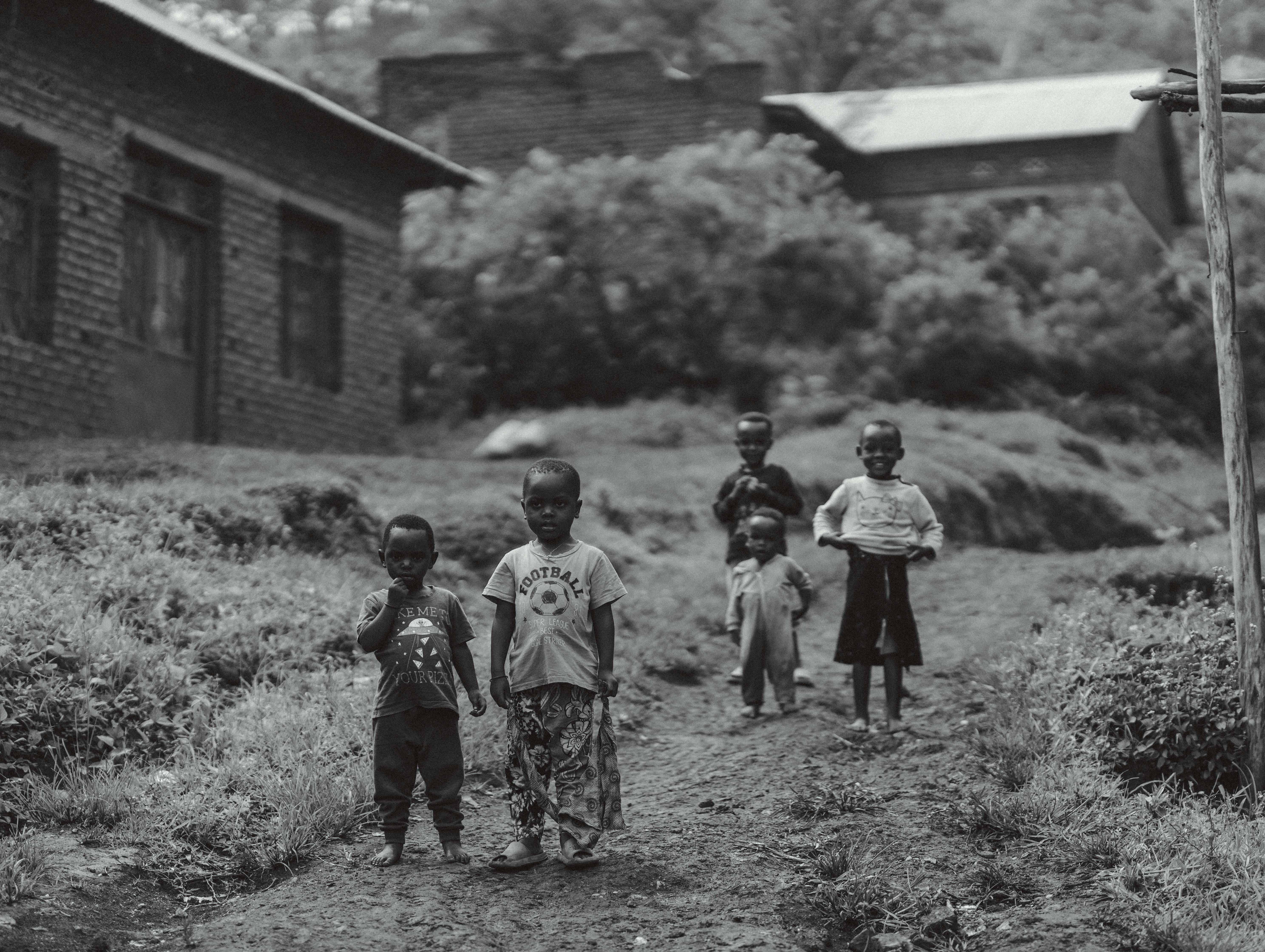 Group of children in a rural village showcasing childhood and community.