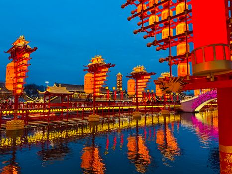 Beautiful evening view of the vibrant traditional Chinese lanterns reflecting in the lake.