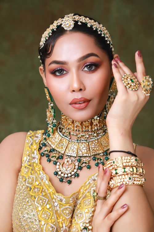 Free Stunning Indian woman adorned in traditional jewelry and warm-toned makeup. Stock Photo