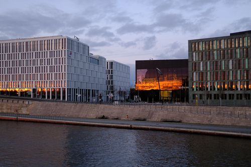 Free Urban skyline of Berlin with modern architecture and office buildings by the river at twilight. Stock Photo