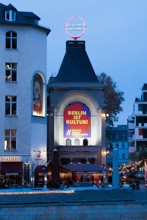 Free Evening view of Berliner Ensemble with vibrant 'Berlin ist Kultur' sign in Berlin, Germany. Stock Photo