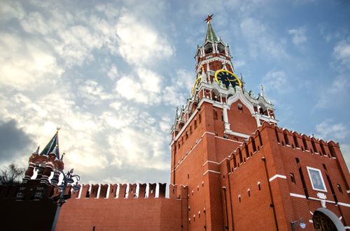 Free View of the Spasskaya Tower of the Moscow Kremlin against a cloudy sky. Architectural landmark. Stock Photo