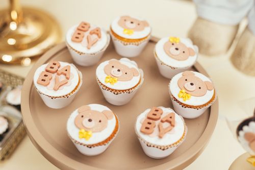 Free Cute baby shower cupcakes featuring bear decorations and BABY lettering on a stylish tray. Stock Photo
