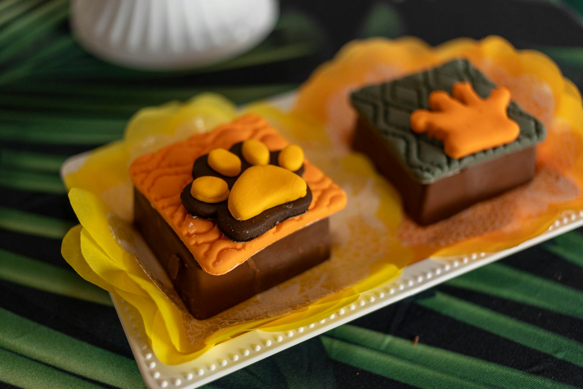 Festive chocolate desserts with animal paw designs, beautifully presented on a plate.