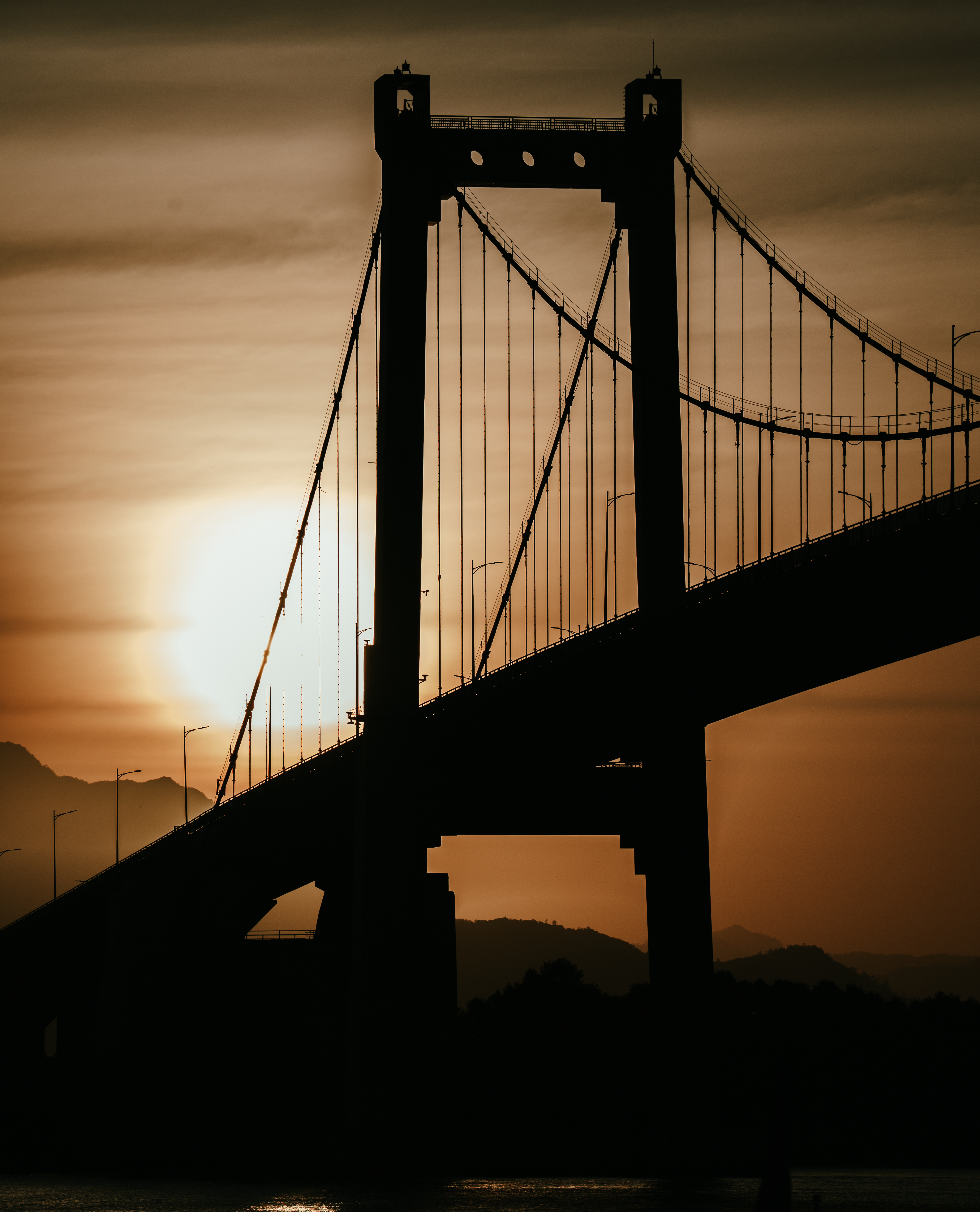 Sunset Silhouette of a Suspension Bridge · Free Stock Photo