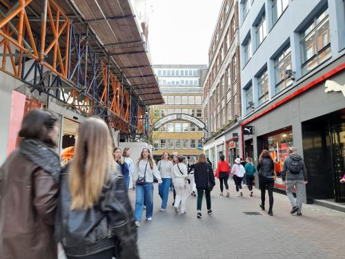 Free Shoppers and pedestrians walking along bustling Carnaby Street in London. Stock Photo