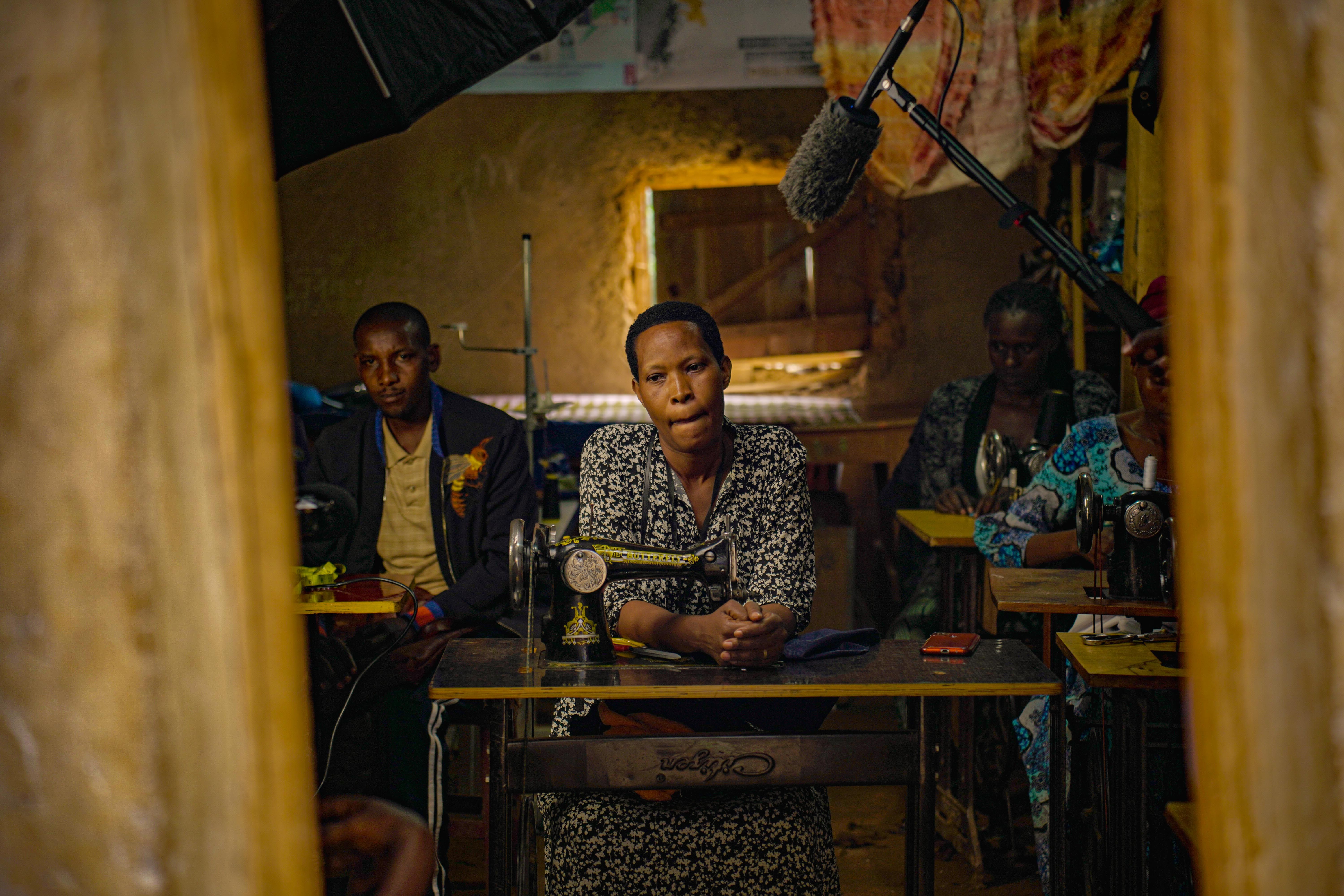 Young women in a tailoring workshop in Ho, Ghana, with sewing machines and fabric