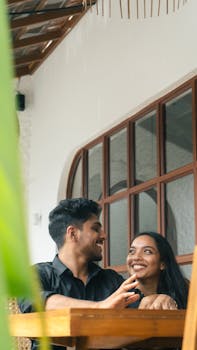 A happy couple cherishing a moment in a cozy café setting, sharing smiles and warmth.